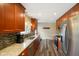 Open kitchen design with wood cabinets, stone countertops and backsplash, and stainless appliances at 1506 Bowman Dr, Greenfield, IN 46140