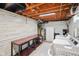 Bright laundry room with modern appliances, wooden ceiling, and shelving for organized storage at 1506 Bowman Dr, Greenfield, IN 46140