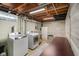 Clean laundry area with updated washer/dryer, exposed ceiling, and ample workspace at 1506 Bowman Dr, Greenfield, IN 46140