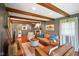 Comfortable living room with wooden beams, large windows and brick fireplace at 1506 Bowman Dr, Greenfield, IN 46140