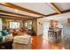 Open concept living and dining area with wooden beams and view into updated kitchen at 1506 Bowman Dr, Greenfield, IN 46140