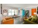 Bright living room featuring hardwood floors, modern furniture, and a vibrant blue door at 1506 Bowman Dr, Greenfield, IN 46140