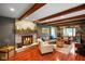 Cozy living room featuring a brick fireplace, wooden beams, and comfortable seating at 1506 Bowman Dr, Greenfield, IN 46140