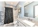 Well-lit bathroom featuring a modern sink and a shower with a shower curtain at 15097 Thoroughbred Dr, Fishers, IN 46040