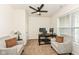 Cozy home office features two chairs, neutral carpet, and an elegant ceiling fan at 15097 Thoroughbred Dr, Fishers, IN 46040