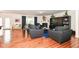Open-concept living room with hardwood floors, modern decor, and ample natural light at 15097 Thoroughbred Dr, Fishers, IN 46040