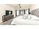 Bright main bedroom with plush bed, sitting area, and lots of natural light at 15097 Thoroughbred Dr, Fishers, IN 46040