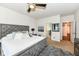 Cozy main bedroom showcasing a large bed, soft rug, and ensuite access at 15097 Thoroughbred Dr, Fishers, IN 46040