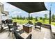 Inviting patio with a fire pit, grill, and comfortable seating for outdoor gatherings at 15097 Thoroughbred Dr, Fishers, IN 46040