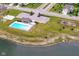 A beautiful community pool with playground overlooking the tranquil lake at 15097 Thoroughbred Dr, Fishers, IN 46040
