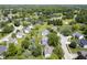 Overhead shot of a neighborhood featuring well-maintained homes, lush greenery, and a tranquil lake at 17916 Racebrook Ct, Noblesville, IN 46062
