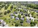 Aerial view of a picturesque neighborhood featuring well-kept homes, mature trees, and a golf course in the distance at 17916 Racebrook Ct, Noblesville, IN 46062