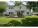 A well-kept backyard featuring a wooden deck, complemented by the home's exterior and lush green lawn at 17916 Racebrook Ct, Noblesville, IN 46062