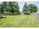 Large, well-maintained backyard with lush green grass and a wooden fence at 17916 Racebrook Ct, Noblesville, IN 46062