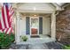 Close-up of a charming front porch with a decorative door and landscaped surroundings at 17916 Racebrook Ct, Noblesville, IN 46062