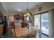 View of eat-in kitchen with wood cabinets, an island, and a sliding glass door to the deck at 17916 Racebrook Ct, Noblesville, IN 46062