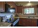 Functional kitchen features an electric range and ample wood cabinetry at 17916 Racebrook Ct, Noblesville, IN 46062