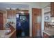 Kitchen area showcasing a black refrigerator, wood cabinets, and access to the living room at 17916 Racebrook Ct, Noblesville, IN 46062