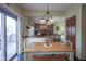 Eat-in kitchen with a wood table and chairs, sliding glass door to the patio, and decorative hanging lights at 17916 Racebrook Ct, Noblesville, IN 46062