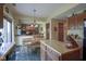 Open eat-in kitchen with an island, stainless appliances, and a view of the living room fireplace at 17916 Racebrook Ct, Noblesville, IN 46062