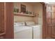 The laundry room has a washer, dryer, and storage shelf at 17916 Racebrook Ct, Noblesville, IN 46062