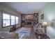 Bright living room with a brick fireplace, built-in shelving, and large windows at 17916 Racebrook Ct, Noblesville, IN 46062
