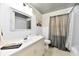 Bright bathroom with a white vanity, stylish mirror, and shower with curtain at 1910 Ivy Dr, Anderson, IN 46011