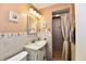 Elegant bathroom featuring single vanity with custom mirror and frameless glass shower enclosure at 1910 Ivy Dr, Anderson, IN 46011