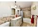 Bathroom with dual vanity, tiled walls, and combination shower and bathtub at 1910 Ivy Dr, Anderson, IN 46011