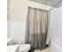 Bright bathroom featuring a shower with a patterned curtain and white tile at 1910 Ivy Dr, Anderson, IN 46011