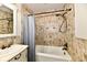Bathroom with tiled walls, and tub with shower at 1910 Ivy Dr, Anderson, IN 46011