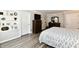 Bedroom with wood floors, dresser, and neutral decor at 1910 Ivy Dr, Anderson, IN 46011