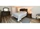 Comfortable bedroom featuring wood floors, a wooden headboard bed, and matching bedside tables at 1910 Ivy Dr, Anderson, IN 46011