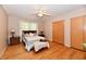 Bright bedroom featuring hardwood floors, ceiling fan and an inviting queen-sized bed at 1910 Ivy Dr, Anderson, IN 46011