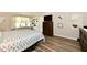 Neutral bedroom with wood floors, soft natural light, and a dresser below a wall-mounted TV at 1910 Ivy Dr, Anderson, IN 46011