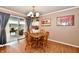 Cozy dining area with wood table, chairs, and a sliding glass door to outdoor space at 1910 Ivy Dr, Anderson, IN 46011
