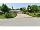 Attractive home with a well-maintained lawn, colorful flowerbeds, and a paved driveway at 1910 Ivy Dr, Anderson, IN 46011