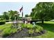 Beautiful landscaping in the front yard features a variety of plants and a lush green lawn at 1910 Ivy Dr, Anderson, IN 46011