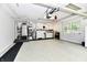 Spacious garage with epoxy flooring, equipped with laundry and utility appliances at 1910 Ivy Dr, Anderson, IN 46011