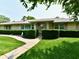 Charming brick home with well-manicured landscaping and a concrete walkway leading to the front door at 1910 Ivy Dr, Anderson, IN 46011