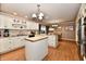 Well-lit kitchen with an island, pendant lighting, stainless appliances, and hardwood floors at 1910 Ivy Dr, Anderson, IN 46011