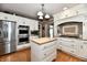 Modern kitchen featuring stainless steel appliances, custom cabinetry, and a large island for food preparation at 1910 Ivy Dr, Anderson, IN 46011