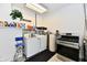 Functional laundry area with washer, dryer, utility sink, and plenty of storage space at 1910 Ivy Dr, Anderson, IN 46011