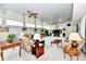Bright living room with ample seating, ceiling fan, and natural light from several windows at 1910 Ivy Dr, Anderson, IN 46011