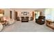 Inviting living room with neutral-toned furniture, a wreath on the front door, and a view of the entry at 1910 Ivy Dr, Anderson, IN 46011