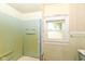 Small bathroom featuring an outdated shower, window and light blue tiling at 2009 S L St, Elwood, IN 46036