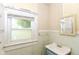 Small bathroom featuring an outdated sink and light blue tiling, plus a large window at 2009 S L St, Elwood, IN 46036