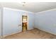 Bedroom featuring light blue wood paneled walls and doorway leading to a kitchen at 2009 S L St, Elwood, IN 46036