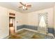 A bedroom featuring wallpaper and blue trim is ready for renovation at 2009 S L St, Elwood, IN 46036