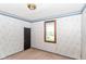 A bedroom is freshly painted with patterned wallpaper and hardwood trim at 2009 S L St, Elwood, IN 46036